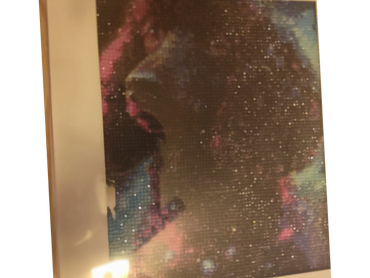 A sparkling pixelated artwork of a dog with a cosmic background.