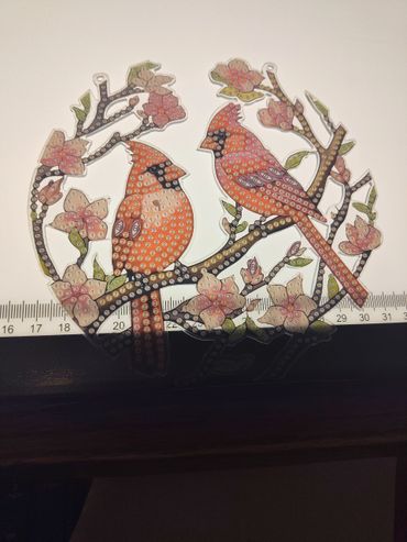 Paint-by-numbers cardinals on a blooming branch with ruler background.