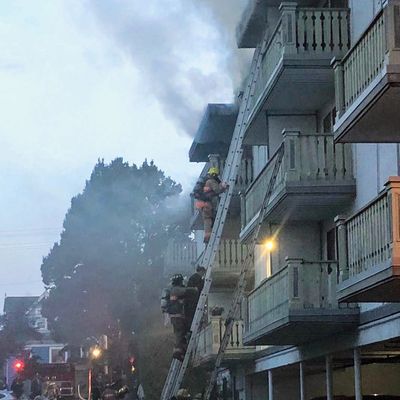 Saanich and Oak Bay Firefighters rescue occupants using ground ladders.