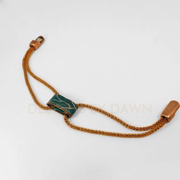 This mesh bracelet has a ammonia copper patina tube that has been etched for accent.