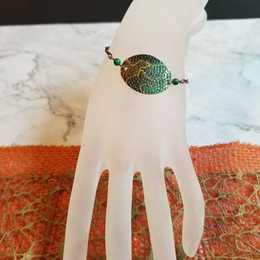 This copper bracelet has been colored using alcohol ink.