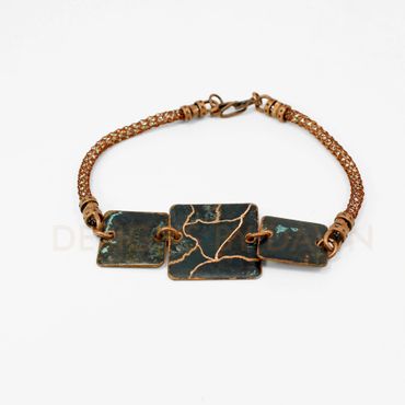 This multi piece copper bracelet has a ammonia patina finish with etching to create pattern.