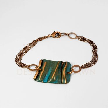 This folded copper bracelet has an ammonia patina finish with sanded folds to create depth.