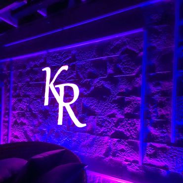 pergola finished with Evolve Stone veneer, LED lighting, and a custom family crest in Runnemede NJ