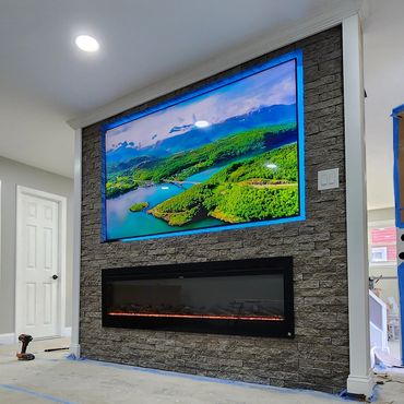 Custom TV and fireplace feature wall showcasing Evolve Stone veneer in Mt. Laurel, New Jersey