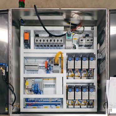 Open industrial control panel with neatly organized electrical components and wiring.