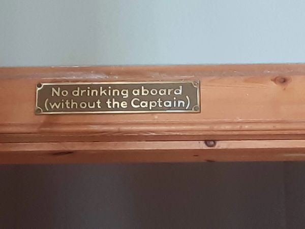 No drinking aboard (without the Captain) write on a wood