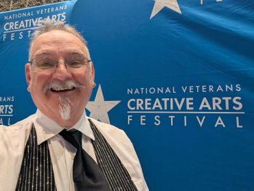 Man smiling at the National Veterans Creative Arts Festival.