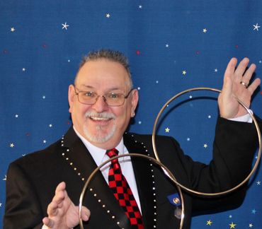 Man performing a magic trick with rings.