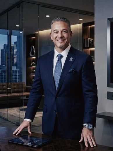 Confident businessman in a suit standing in a modern office.