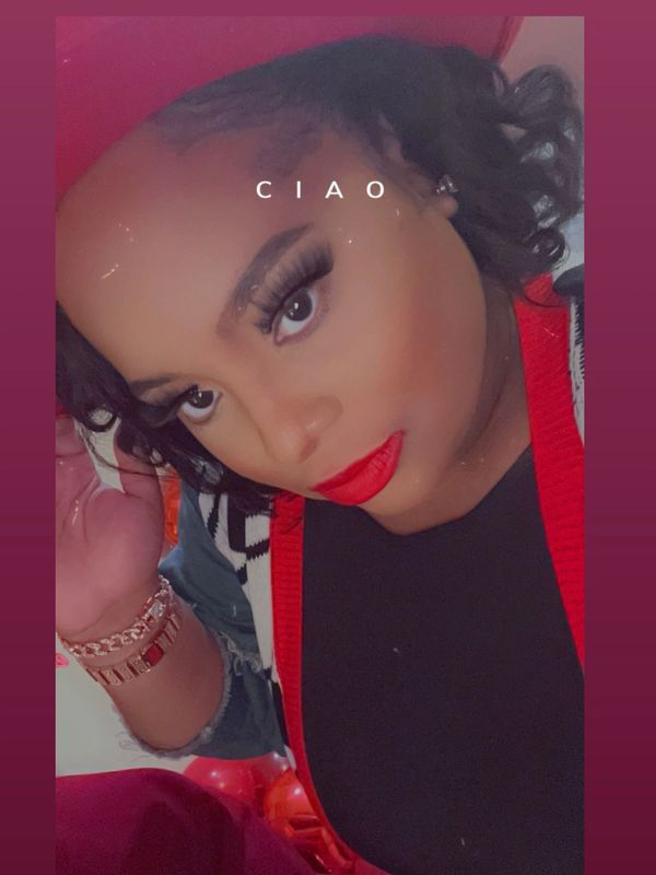 Woman with bold red lipstick and curled hair poses with 'CIAO' text.