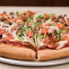 Close-up of a vegetable-topped pizza slice.