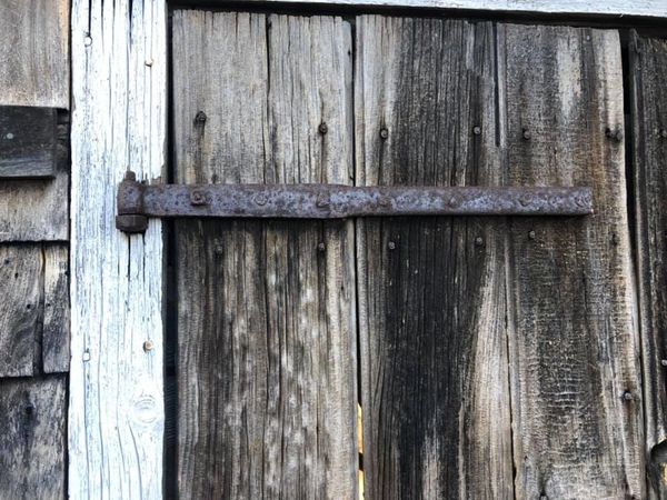 Forged hinge on blacksmith shop door