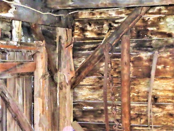 Post and beam view of interior wall at blacksmith shop