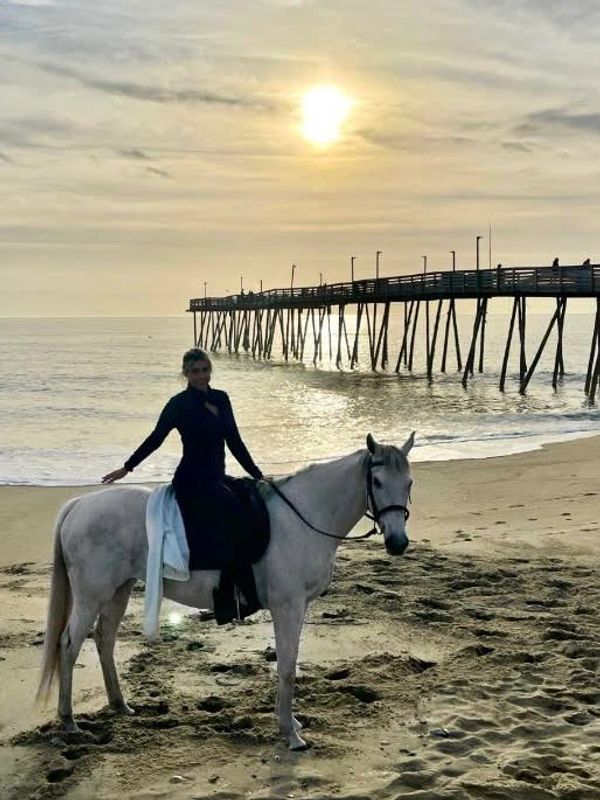Sharee riding her horse on the beach at Avalon Pier in North Carolina