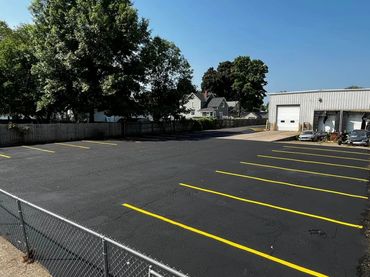 Pothole repair, Crack sealing, seal coating, and line striping at auto care in Sparta, MI