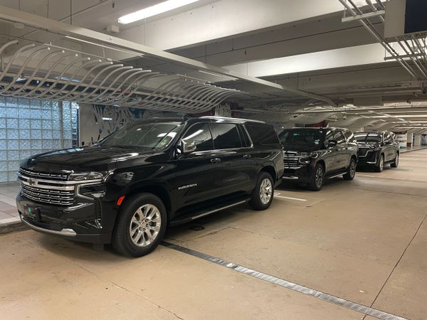 lot of three luxury SUVs at Orlando International Airport holding bay