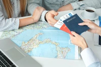 Travel agent with passport and world map