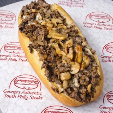 Philly cheesesteak sandwich with mushrooms and onions.
