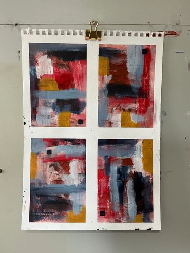 Four abstract paintings with red, blue, yellow, and black colors.