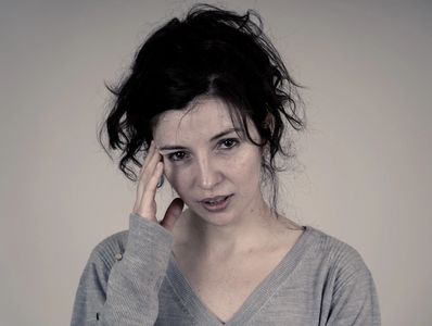 woman with headache migraine from fibromyalgia pain