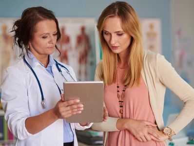 woman talking to doctor about fibromyalgia tests and findings