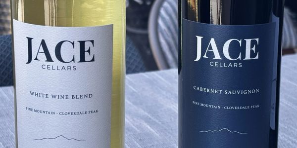Two bottles of Jace Cellars wine, white blend and cabernet sauvignon.