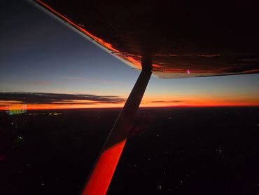 View of a sunset from an airplane wing.