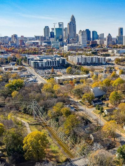 City skyline with autumn trees and residential area.
