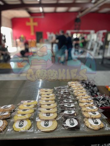 Packaged cookies arranged on a table in a gym setting.