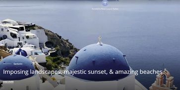 Santorini's iconic blue-domed churches overlook the serene sea and cliffside white buildings.