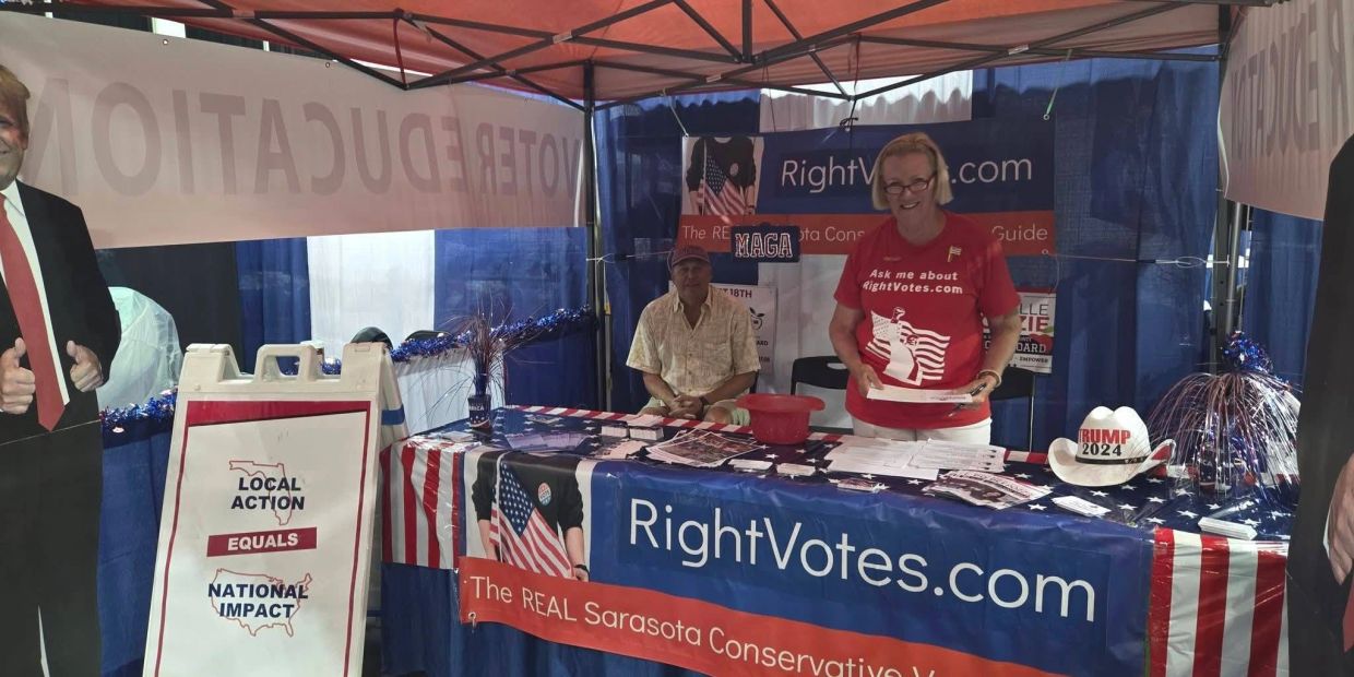 Two people at a conservative RightVotes.com booth.