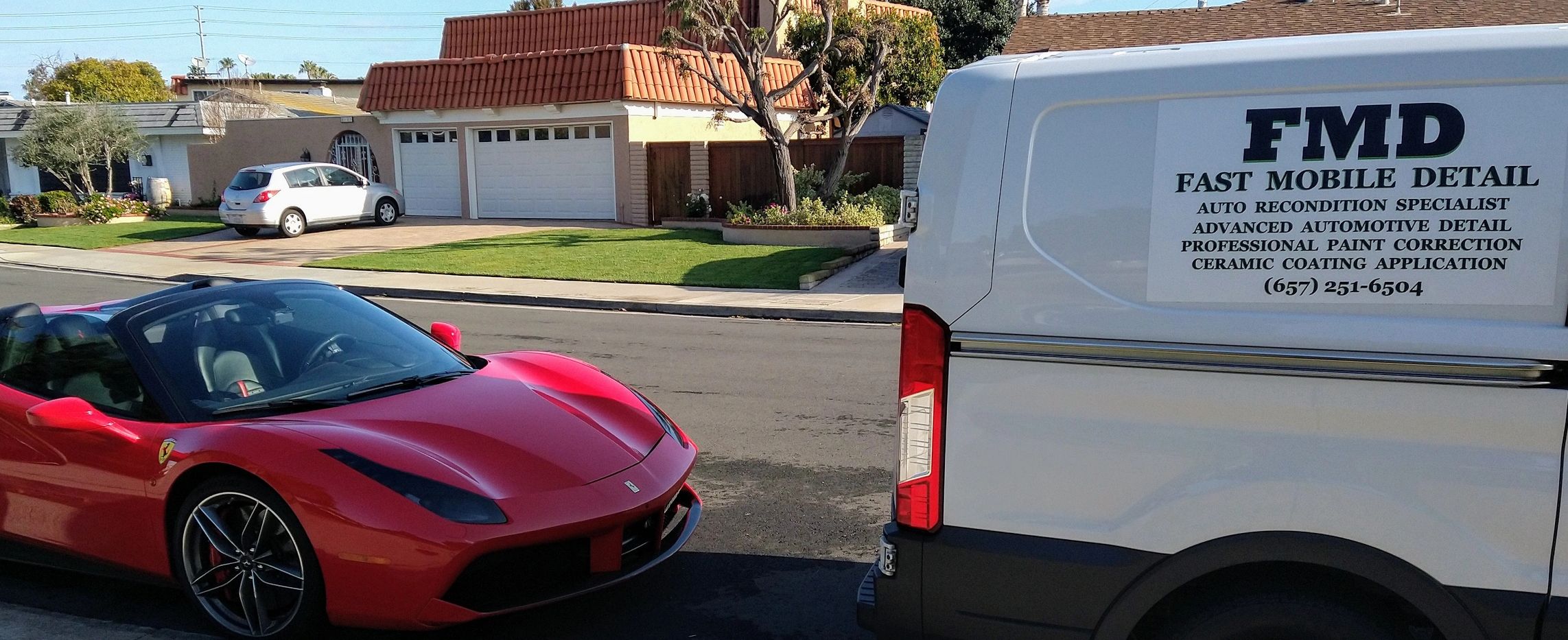 The mobile detail van parked in front of a Ferrari after completing an R1 coating application.