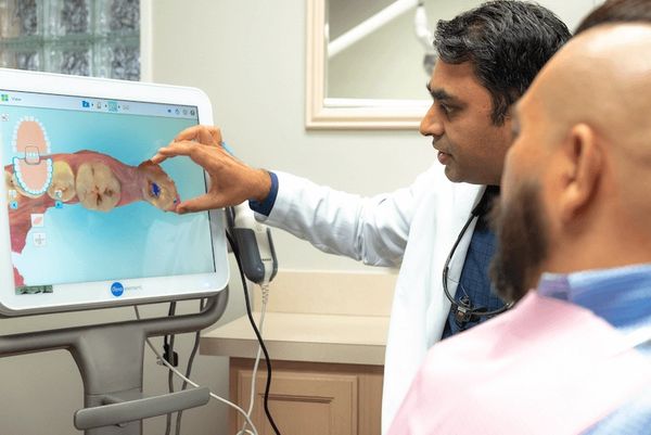 Cosmetic Dentist in Arlington, TX, with patient