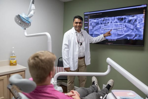 Dr. Ummareddy explaining a x-ray to a patient in the practice