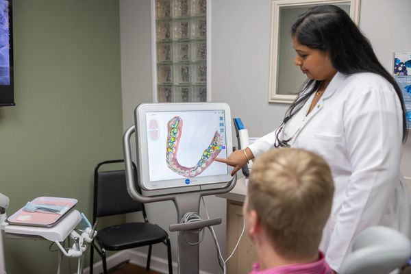 Our restorative dentist in Arlington, TX, explaining a treatment to a patient