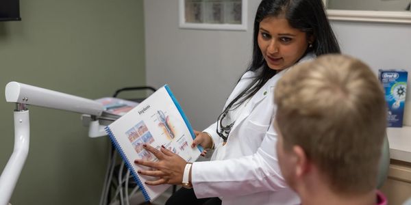 dentist explaining dental implants to a patient in Arlington, TX