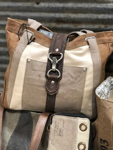 Canvas and leather bag with metal buckle at The Peak in Albertville, MN
