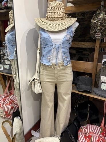 Mannequin wearing a summer outfit with hat and beige pants at The Peak in Albertville, MN