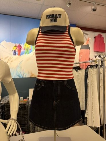 Mannequin dressed in a striped tank top and black skirt with a 'PERSONALITY HIRE' cap at The Peak in Albertville, MN