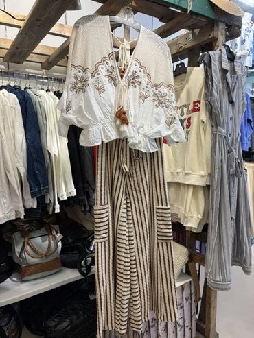 Boho-style embroidered top and striped pants on a hanger at The Peak in Albertville, MN