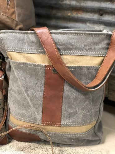 Canvas and leather tote bag with brown strap at The Peak in Albertville, MN