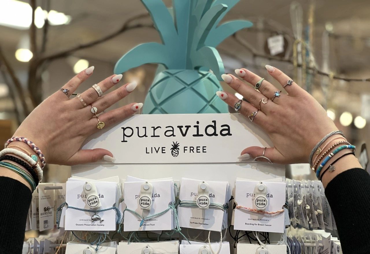 Hands displaying rings and bracelets over Pura Vida display at The Peak in Albertville, MN