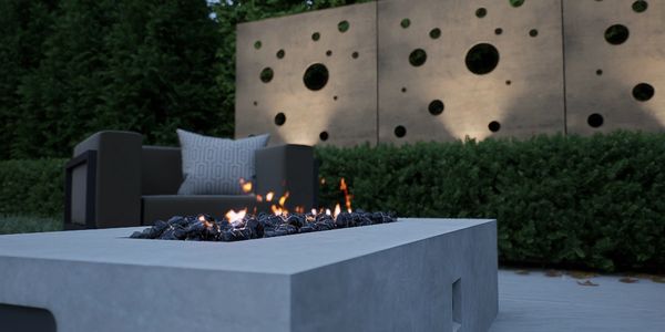 Modern outdoor fire pit with comfortable seating and decorative wall panels.