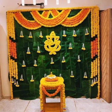 Traditional floral decoration with marigold flowers and banana leaves.
