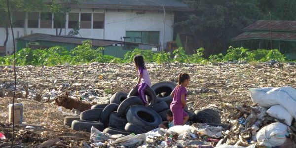 Children playing in a landfill shows the need for improved child health in Indonesia