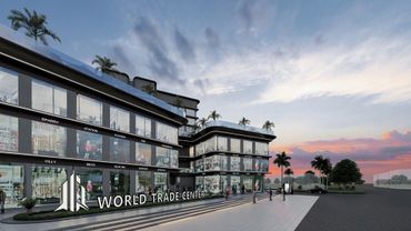 Modern World Trade Center complex with glass facades at sunset.