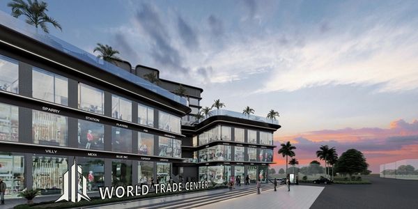 Modern World Trade Center complex with glass facades at sunset.