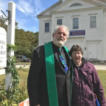 Older couple smiling outside a church.