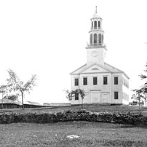 Black and white photo of a church on a hill.
